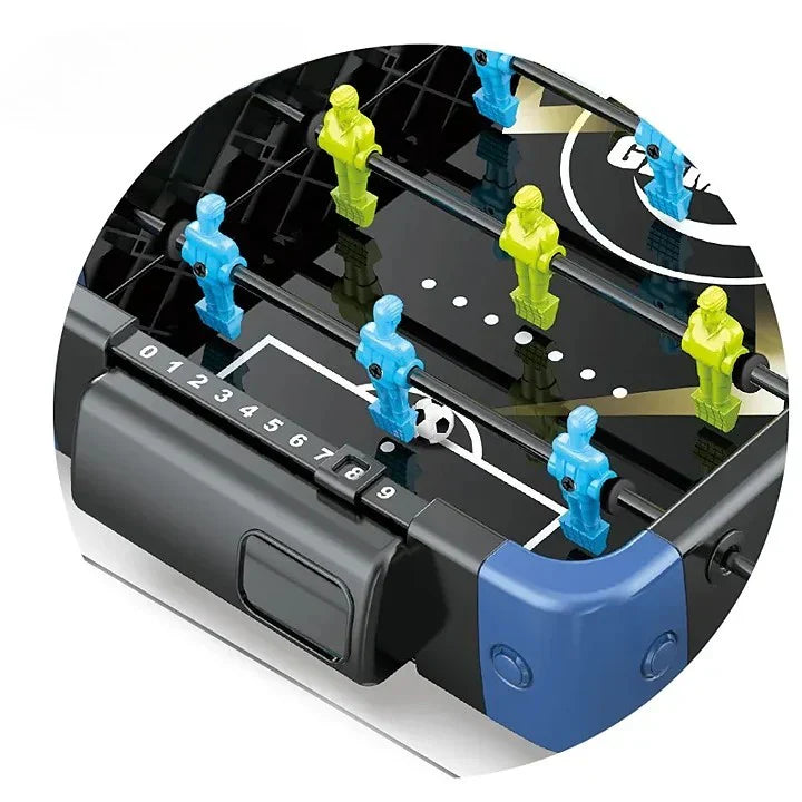 Tabletop foosball game with blue and green figures on a black table.