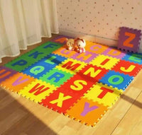 Colorful alphabet mats on a wooden floor with toys and curtains in the background.