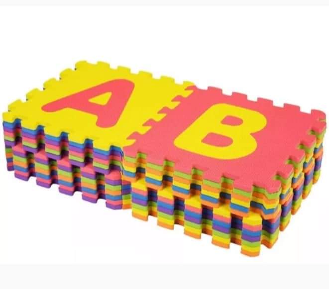 Colorful foam puzzle mats with letters on a white background