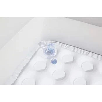 White baby blanket with ruffles and a small blue toy on a white background