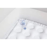 White baby blanket with ruffles and a small blue toy on a white background