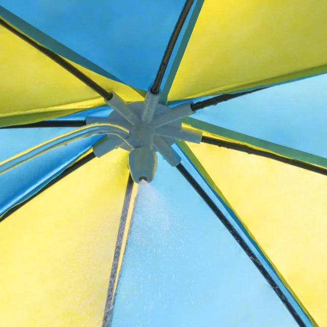 Close-up of a yellow and blue umbrella with water droplets.