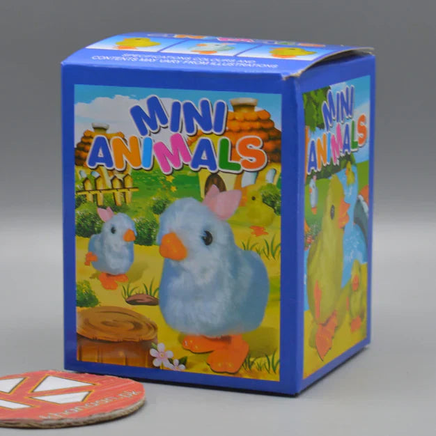 Plush bear toy with a white electronic device inside, on a light surface with books and a small lamp.