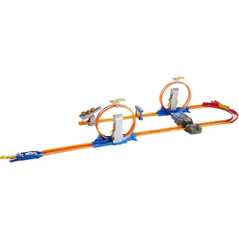 Toy track set with loops and cars on a white background