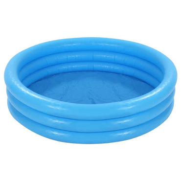 Two children playing in a green inflatable pool on grass with a woman nearby.