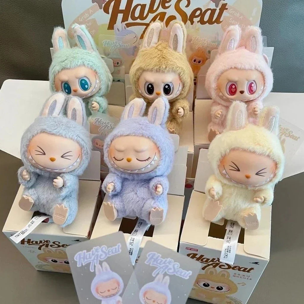 Box of mini animals with colorful packaging on a gray background