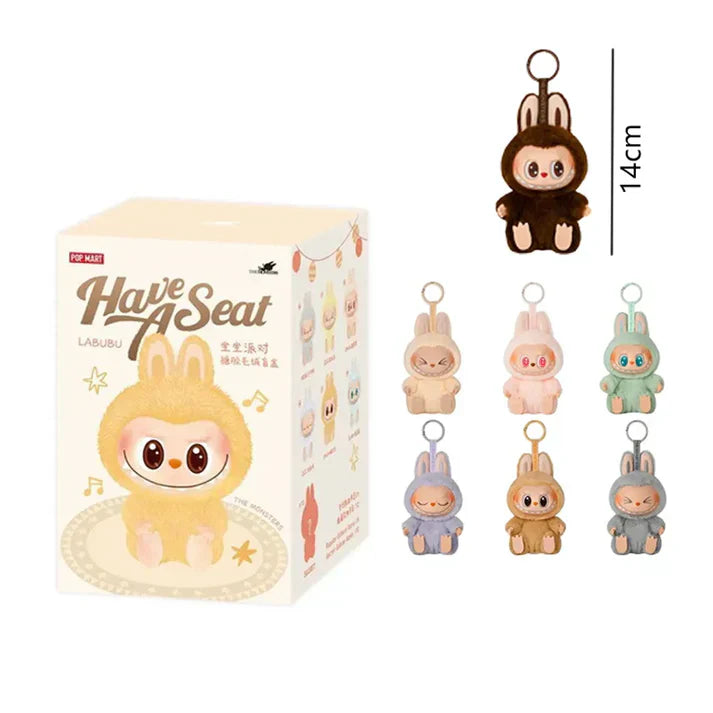 Box of 'Have Seat' plush toys with keychains displayed on a white background