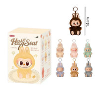 Box of 'Have Seat' plush toys with keychains displayed on a white background