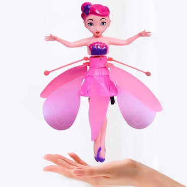 Toy doll with pink outfit and accessories on a white background