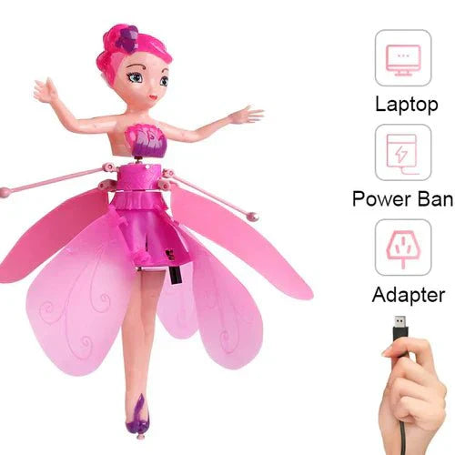 Pink fairy doll with wings, laptop, power bank, and adapter on a white background
