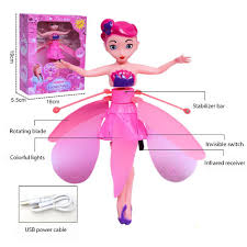 Toy doll with pink outfit and accessories, including packaging and power cable, on a white background.
