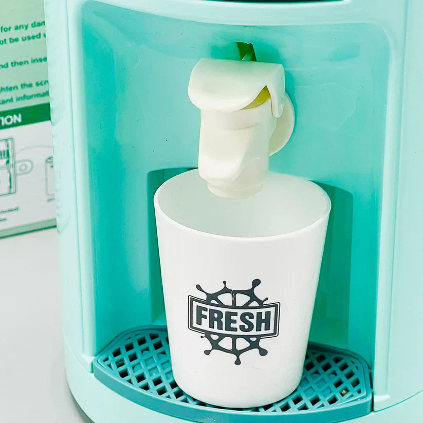 White cup with 'FRESH' logo being filled with water from a teal dispenser.