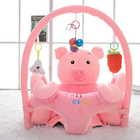 Gray plush elephant toy on a wooden surface with a light background