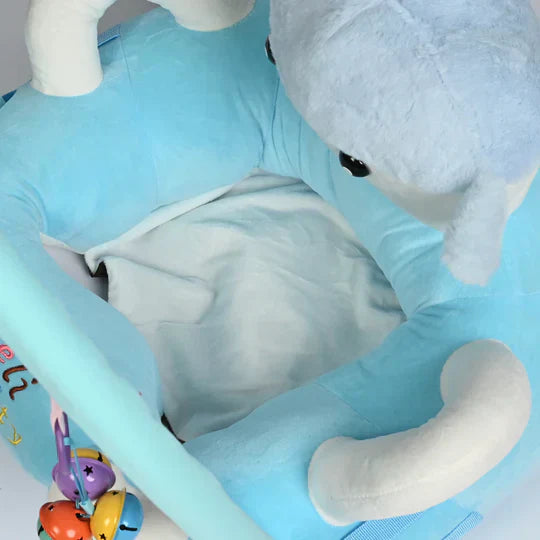 Baby sleeping on a large gray elephant plush toy