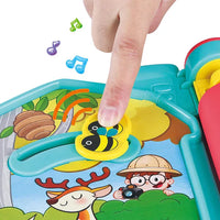 Children's toy with cartoon characters and a bee, featuring a hand interacting with it.
