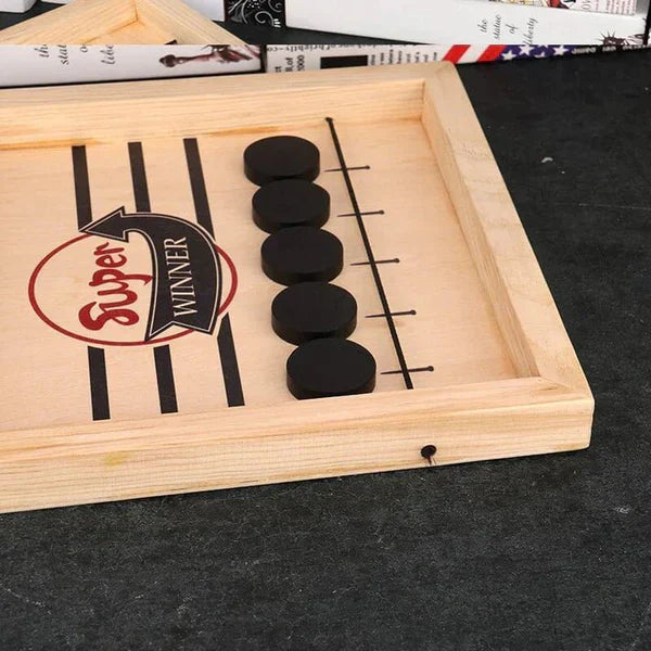 Wooden game board with black stones and 'Super Winner' label on a dark surface