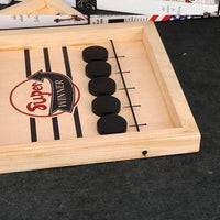 Wooden game board with black stones and 'Super Winner' label on a dark surface