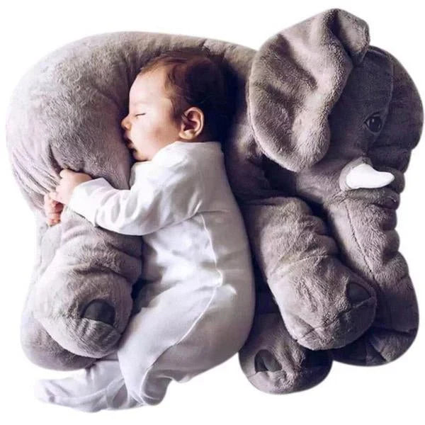 Baby sleeping on a large gray elephant plush toy