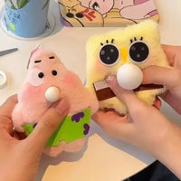 Two plush toys, one pink and one yellow with a chocolate bar, held by hands on a colorful background.