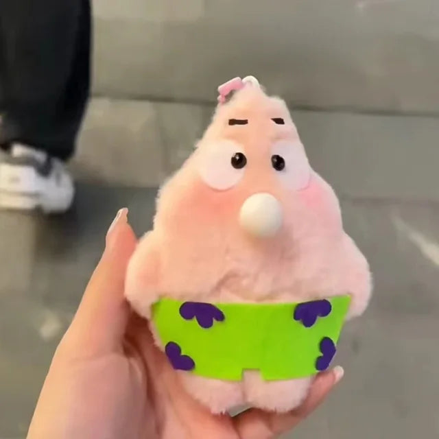 Pink teddy bear plush toy with a small green plant on a wooden surface.