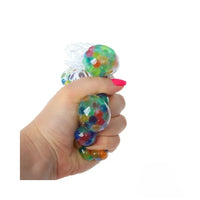 Hand holding a colorful stress ball with a white background